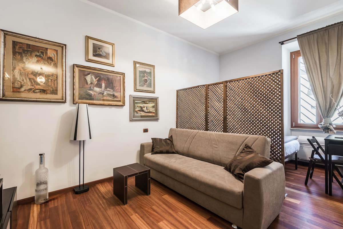 Cozy living room with sofa bed and artwork in our Rome apartment